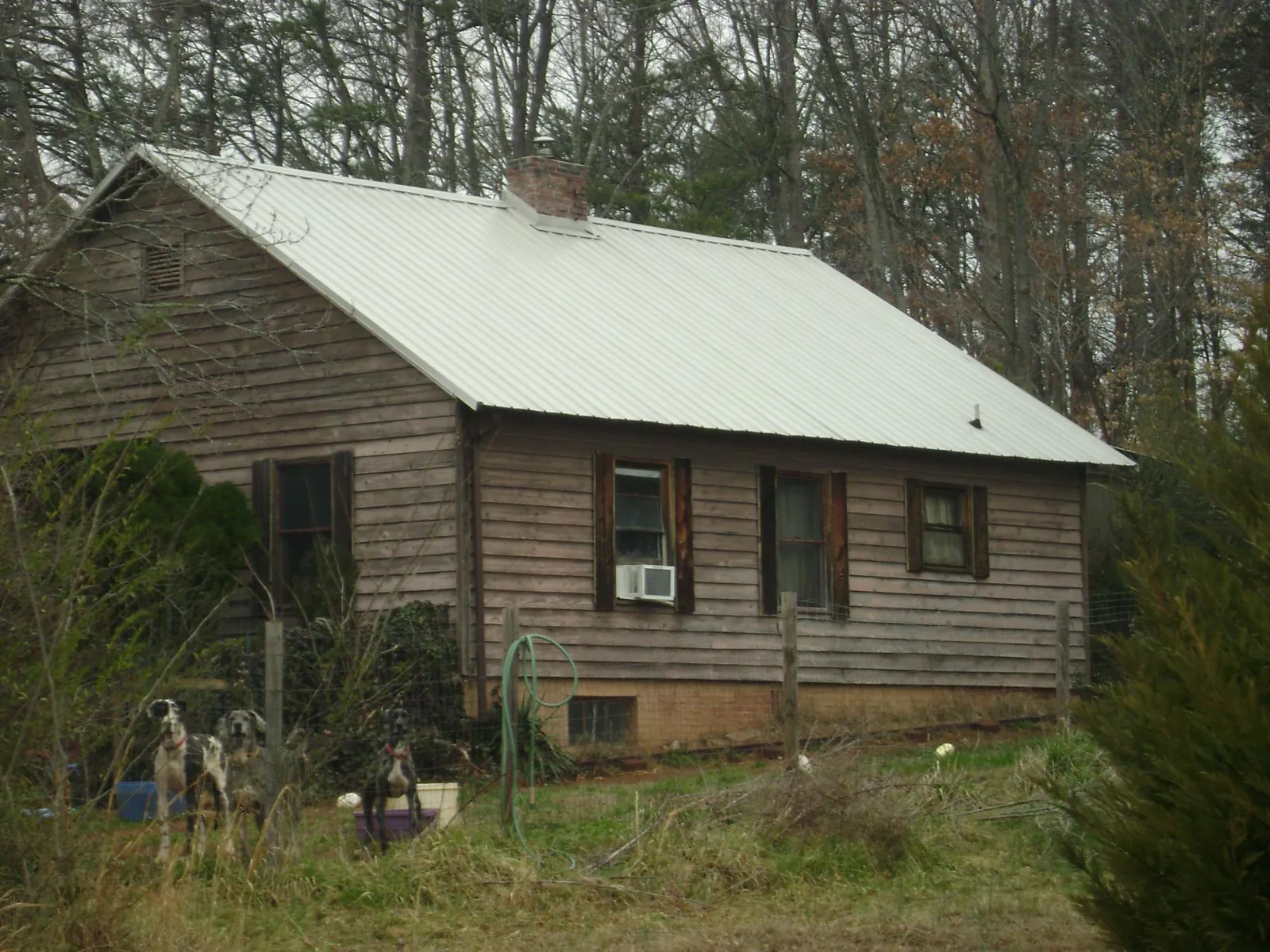 White metal roof on an old wood sided farmhouse, from a Metal Roof Installation job in East Canton